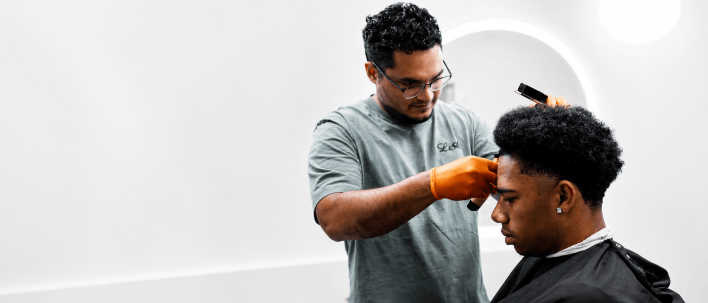 Professional barber performing a precision skin fade haircut in Blaz3 Studio, Charlotte, NC.